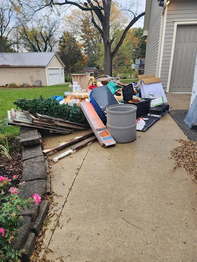 Dumpster being loaded with debris for Estate Cleanout Dumpster Rental in Linton